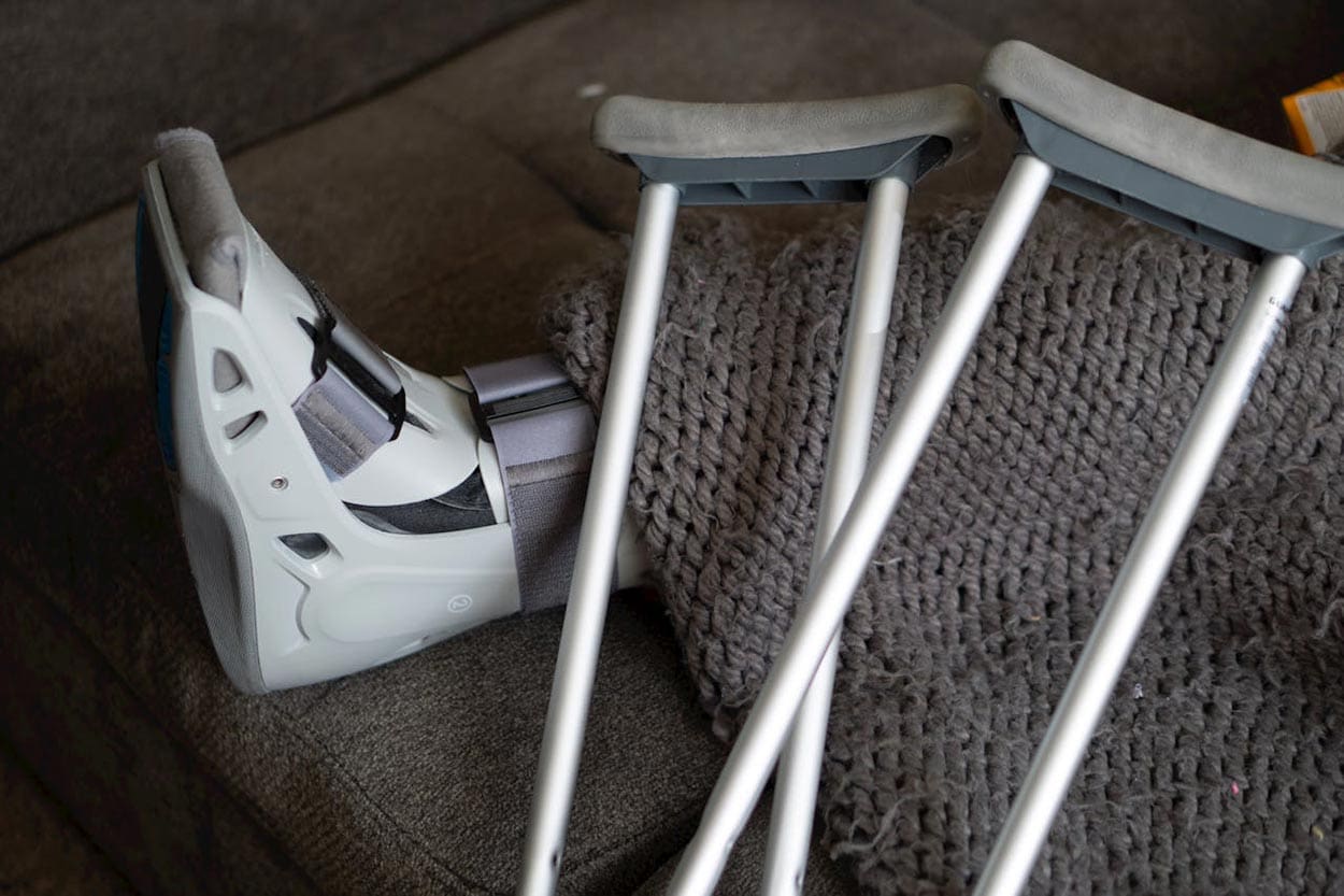 A person with a leg brace and crutches seeking help from a personal injury lawyer in Columbia, SC.