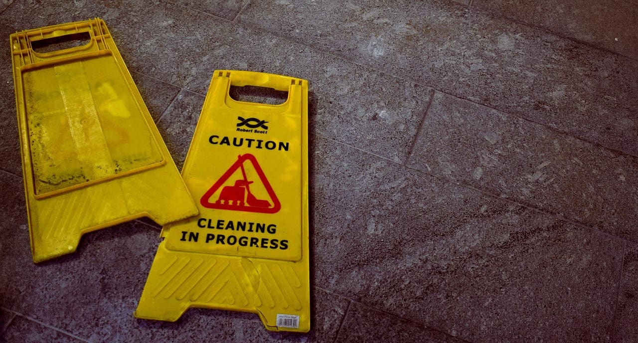 A broken wet floor sign, which could be hypothetically used as evidence by a personal injury law firm