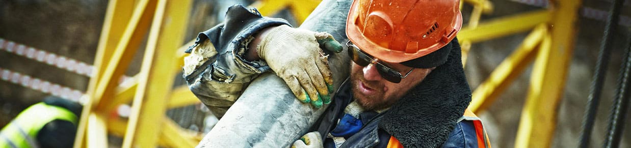A construction worker preparing to file a workers’ compensation settlement against their employer.