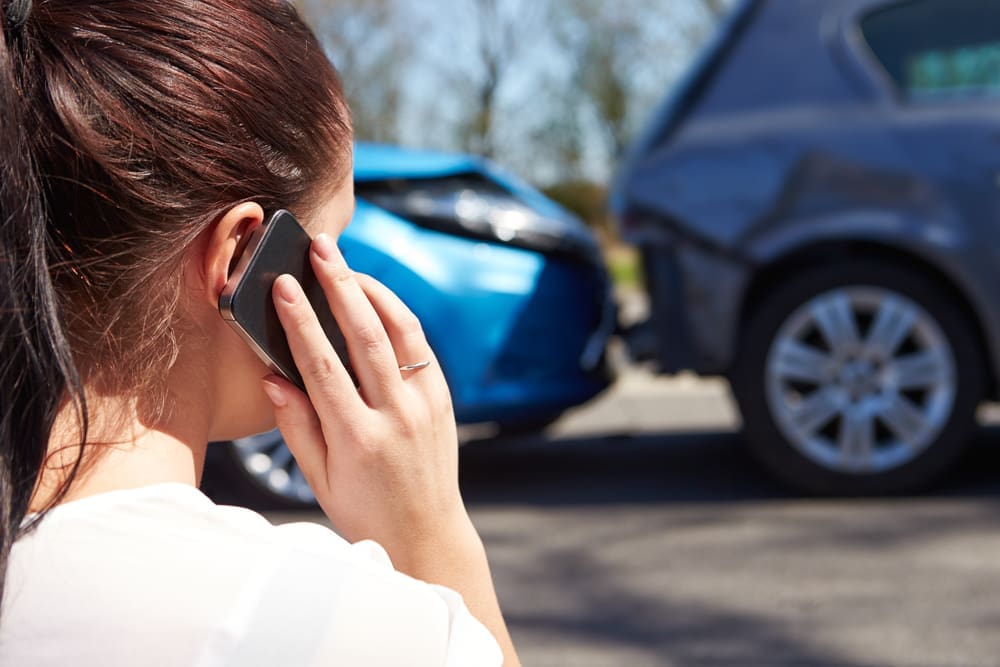 A person calling for help after getting injured in a car accident