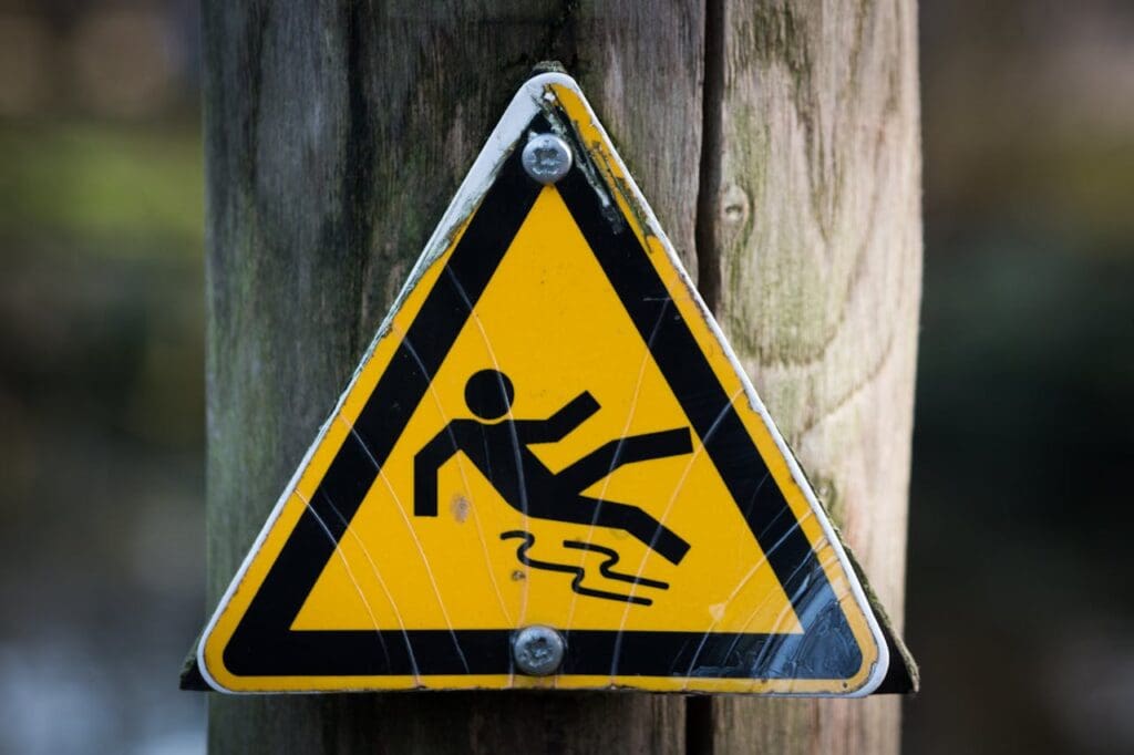 A sign indicating a slip risk, which a property owner displays to avoid premises liability issues