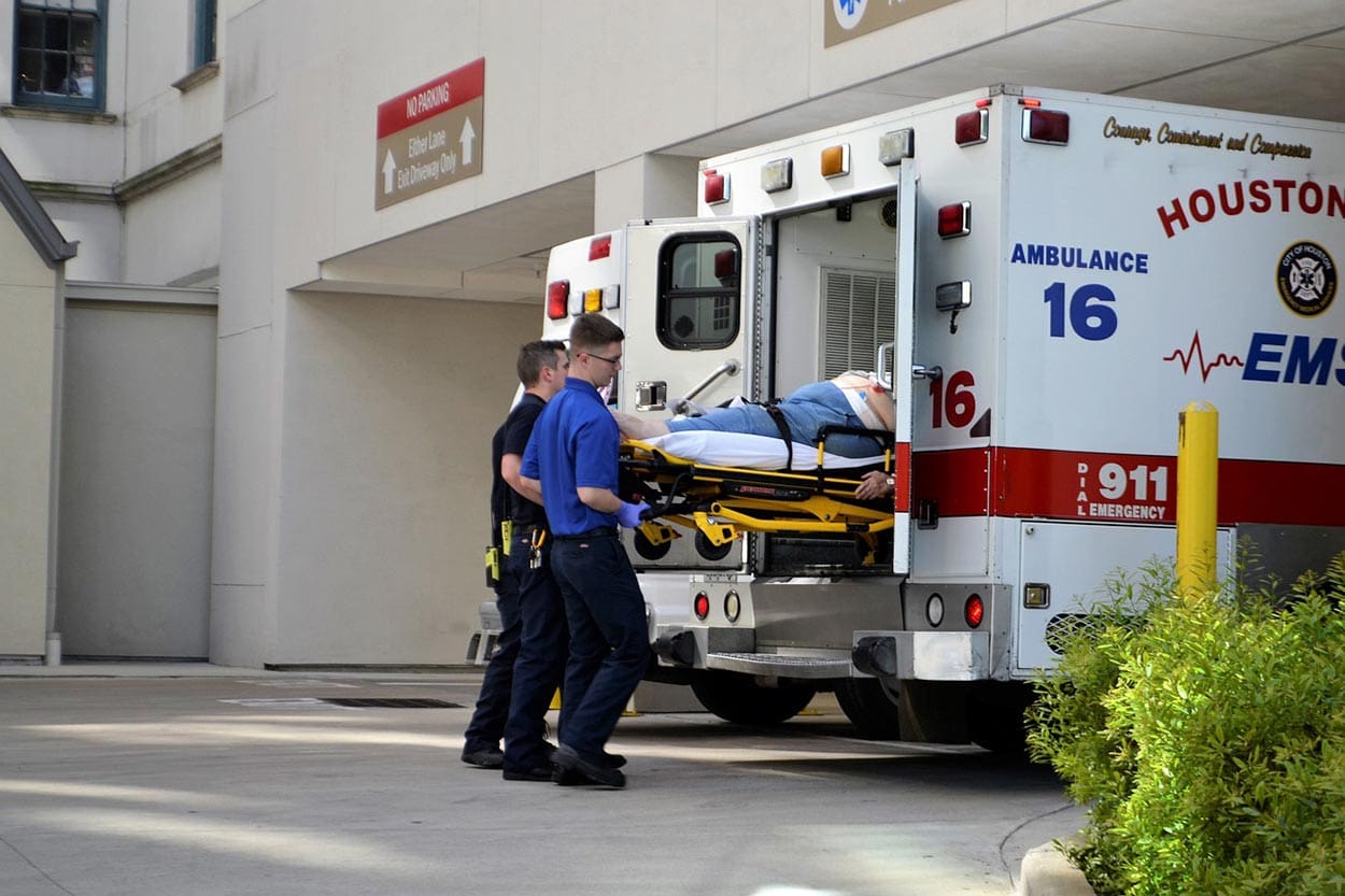 A person being helped into the back of an ambulance before he contacts an SC premises lawyer