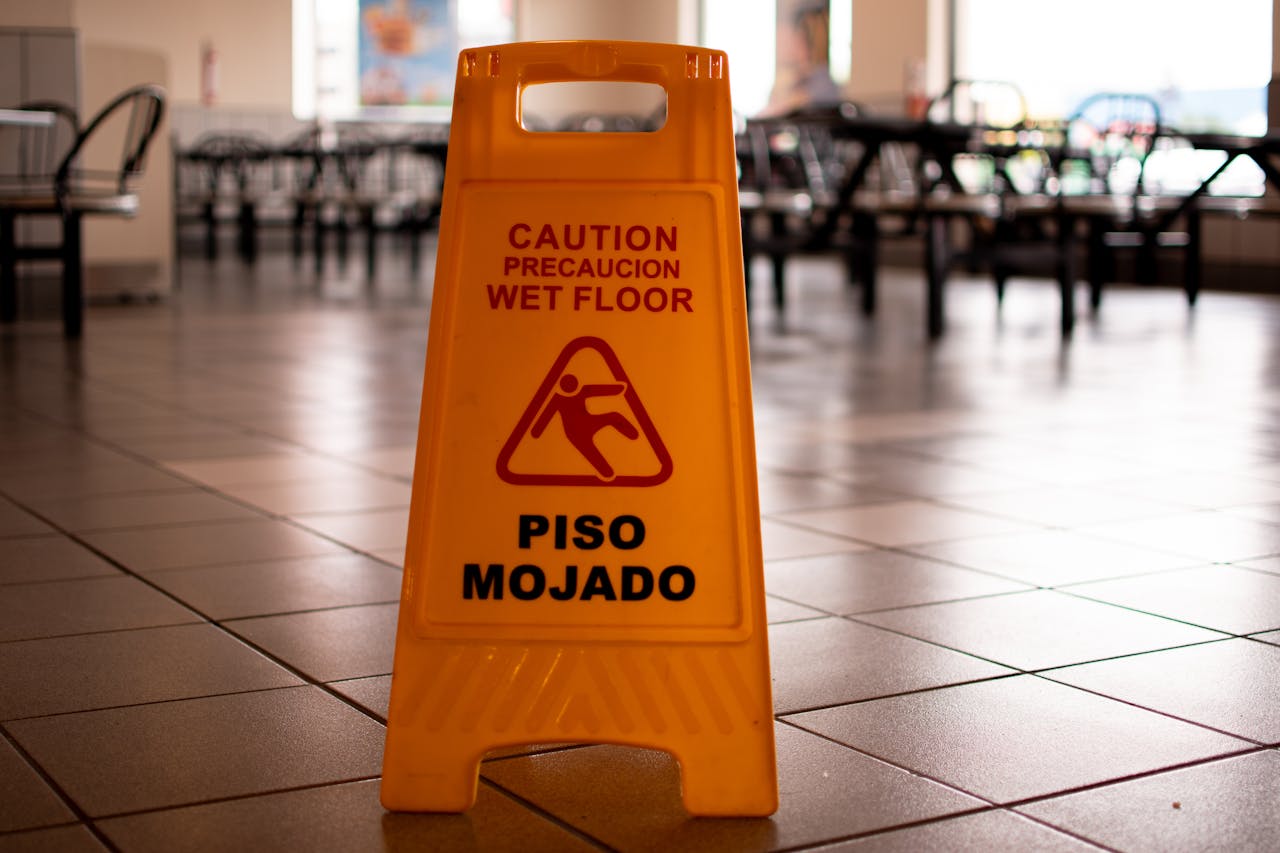 A “wet floor” sign placed standing up on the floor of a restaurant to help prevent premises liability cases in Columbia, SC