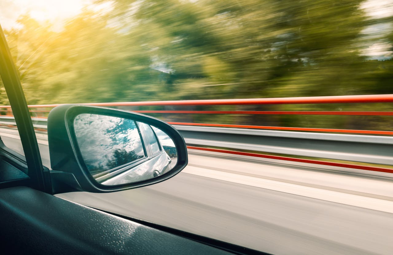 The view out of a side window of a moving automobile