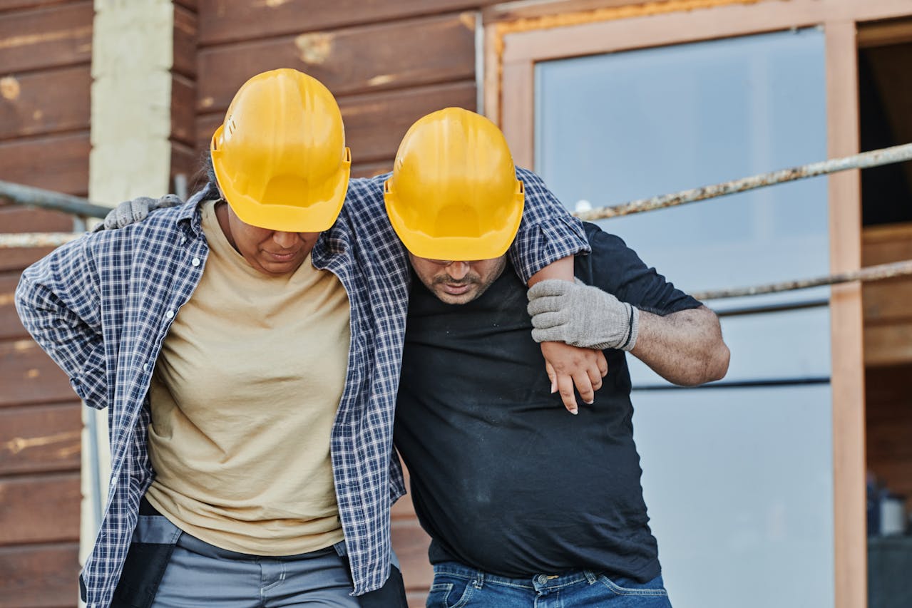 A worker helping an injured co-worker before they form a workers’ comp case in Charleston, SC