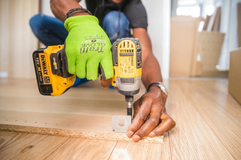 A person using a drill before sustaining a construction injury in Columbia