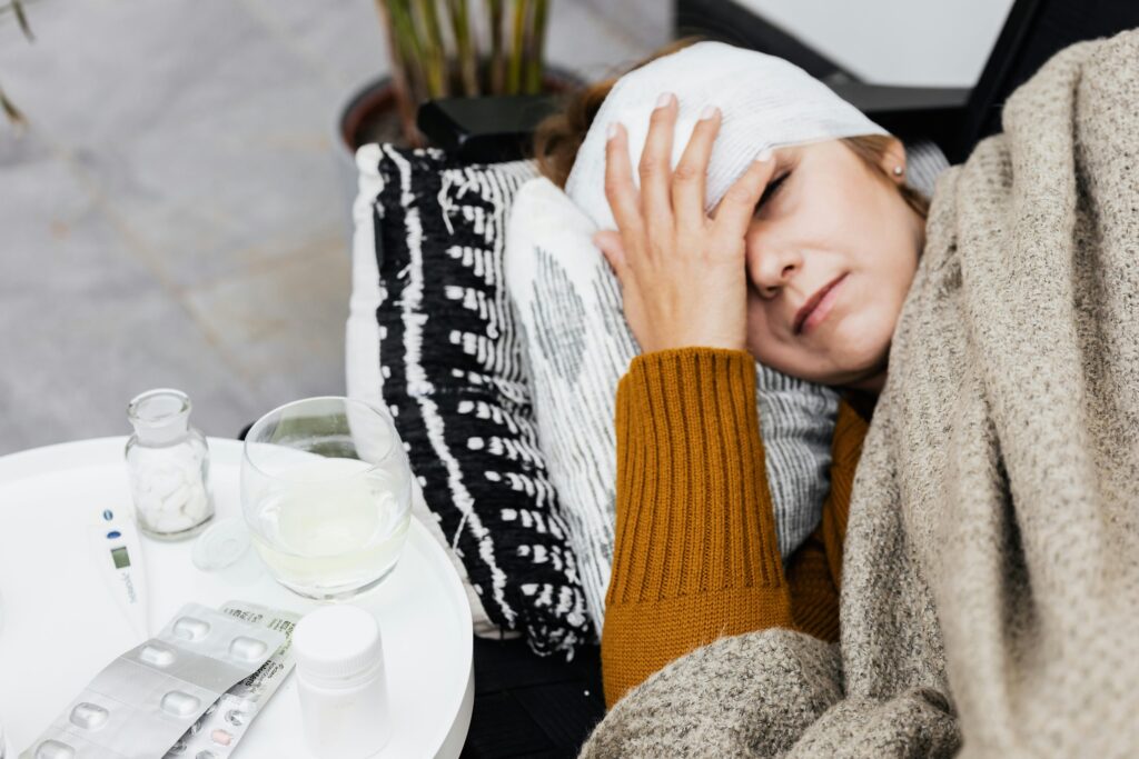 A woman with a bandaged head worrying about the costs of traumatic brain injuries