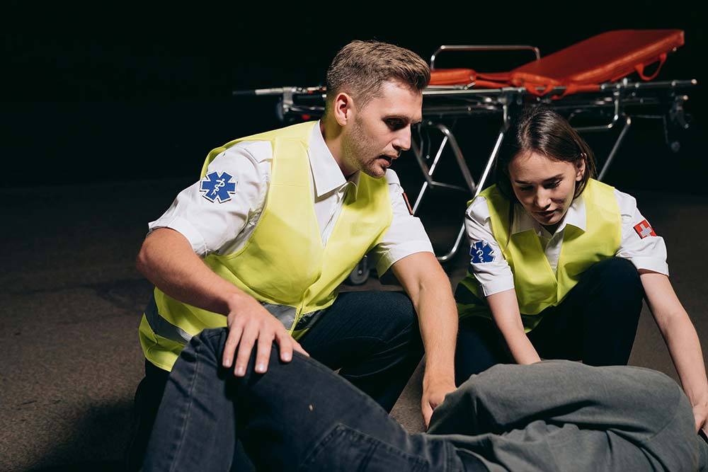 Paramedics helping an injured person before they file an Allendale workers’ comp claim