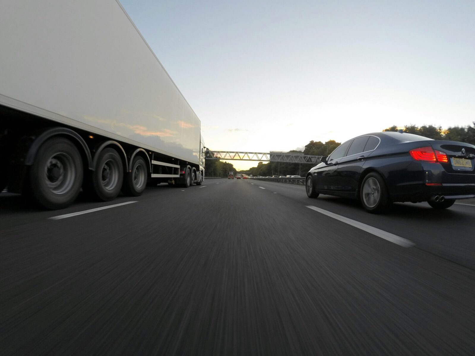 A white semi traveling near a black passenger vehicle before a semi-truck accident in Aiken, South Carolina