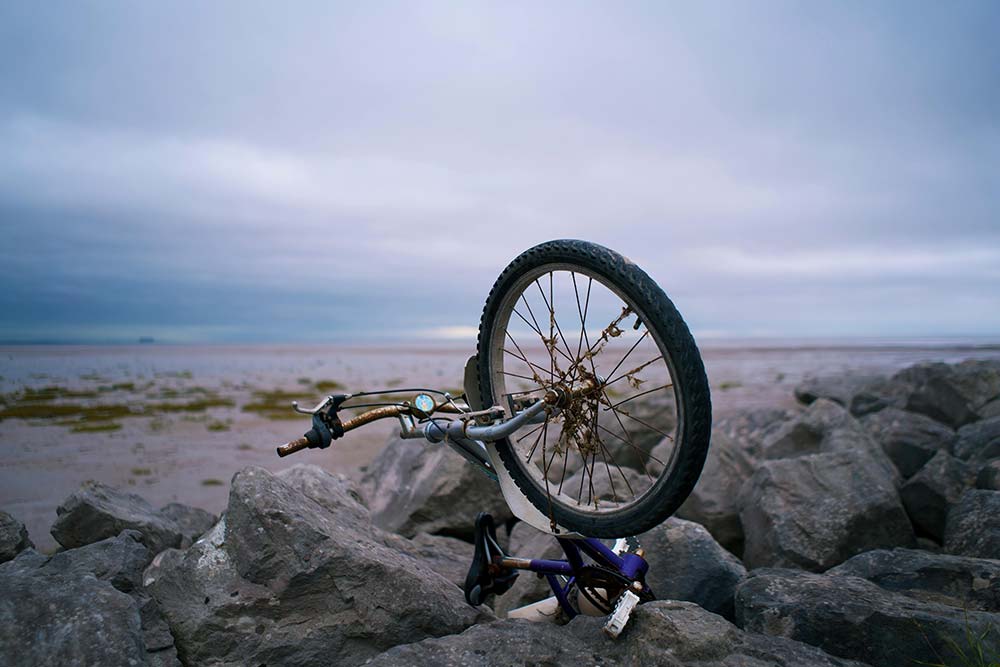 A damaged bike on rocks, which may serve as evidence in bike accident cases