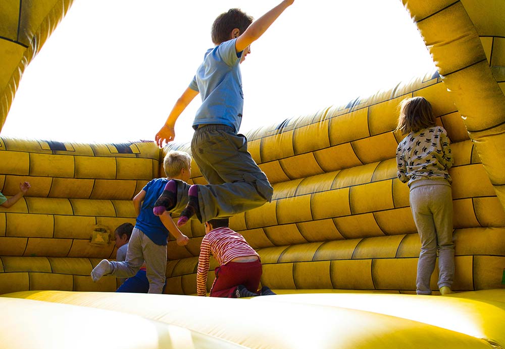 Children jumping in an inflatable castle