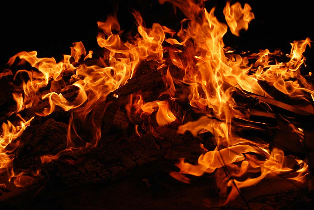 A large fire burning many pieces of wood