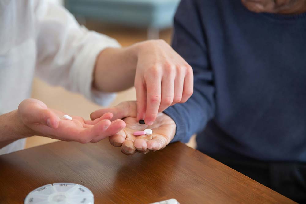 A caregiver giving a patient medication, which can serve as the basis for a nursing home abuse case