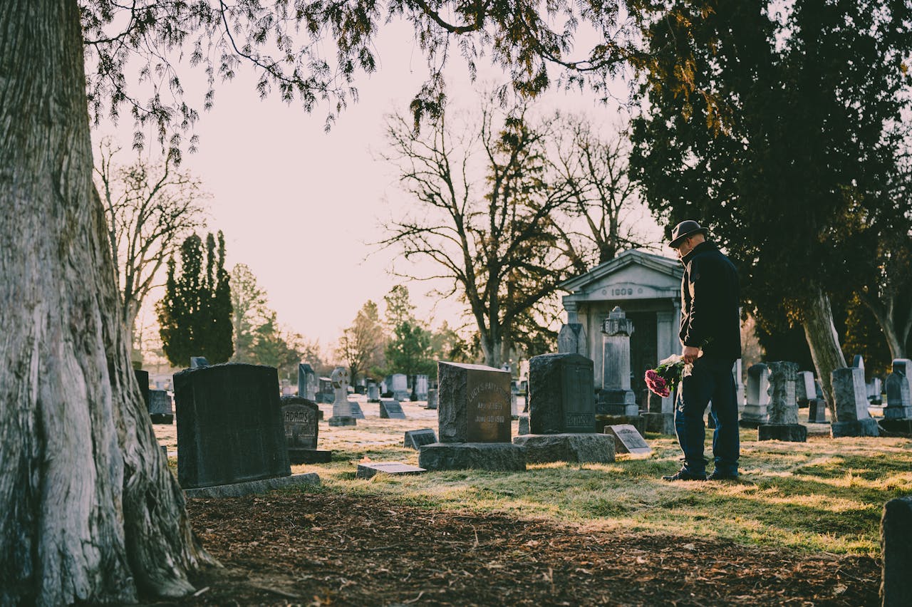 A person involved in a wrongful death case visiting a graveyard