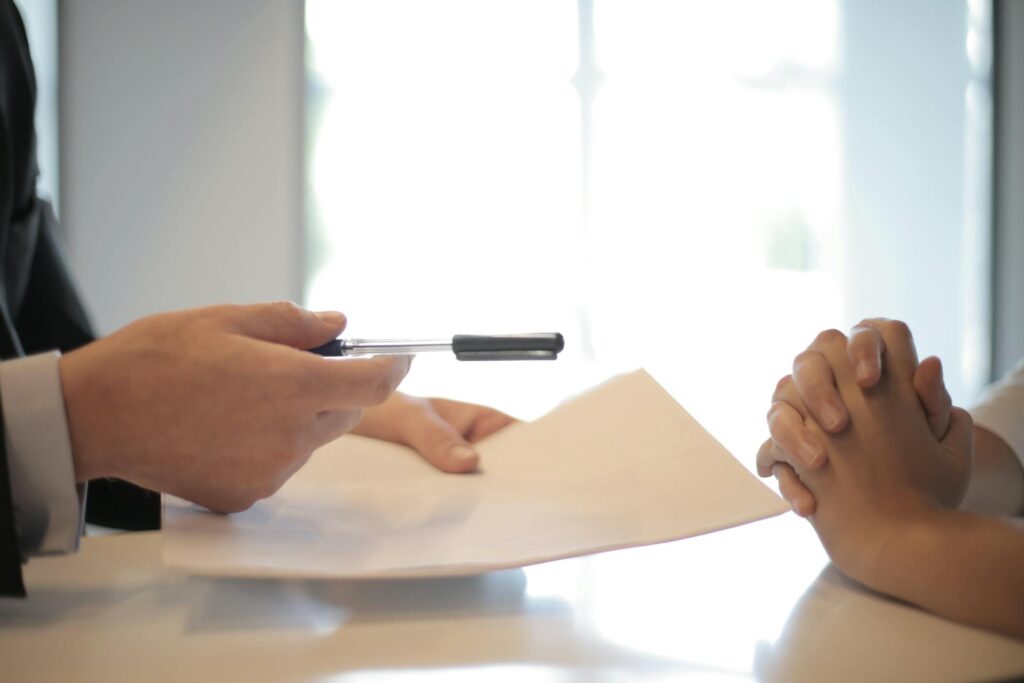 An insurance adjuster handing over papers to someone who sustained a bicycle accident injury in Columbia, SC