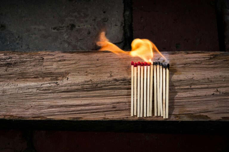 Matches being lit on an old piece of wood