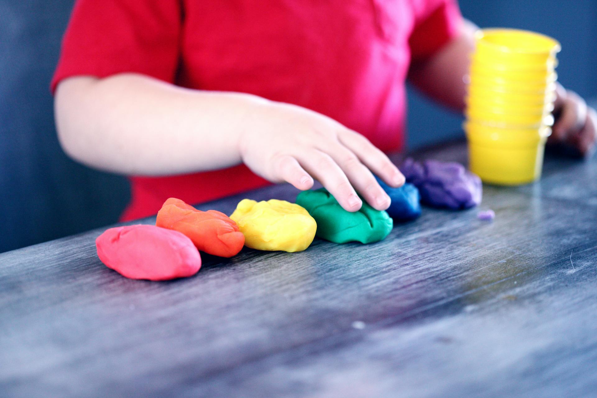 A child playing with clay at a daycare