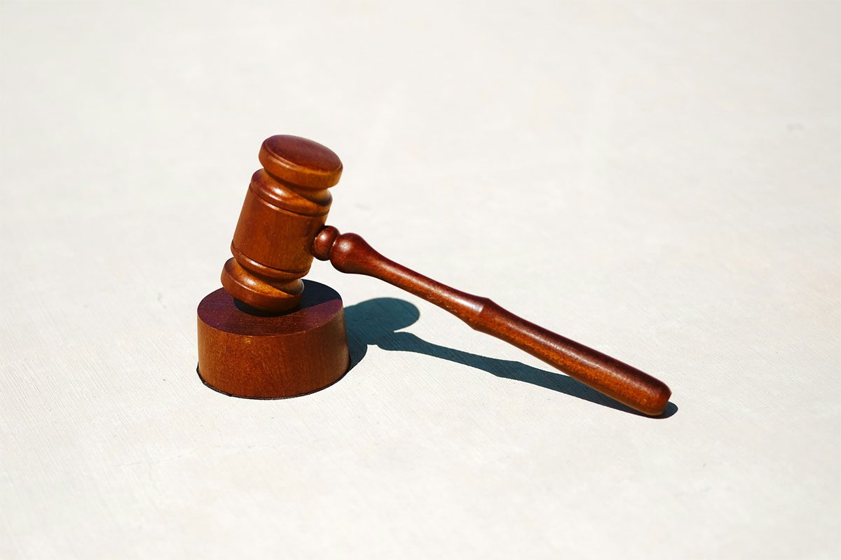 A brown gavel on a white surface, which is something you may see at a Greenville law firm