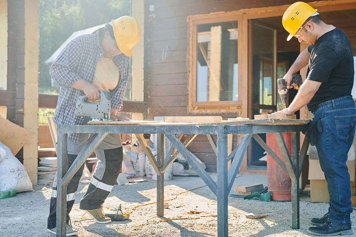 Construction workers working while speaking about contacting a Columbia workers’ compensation lawyer