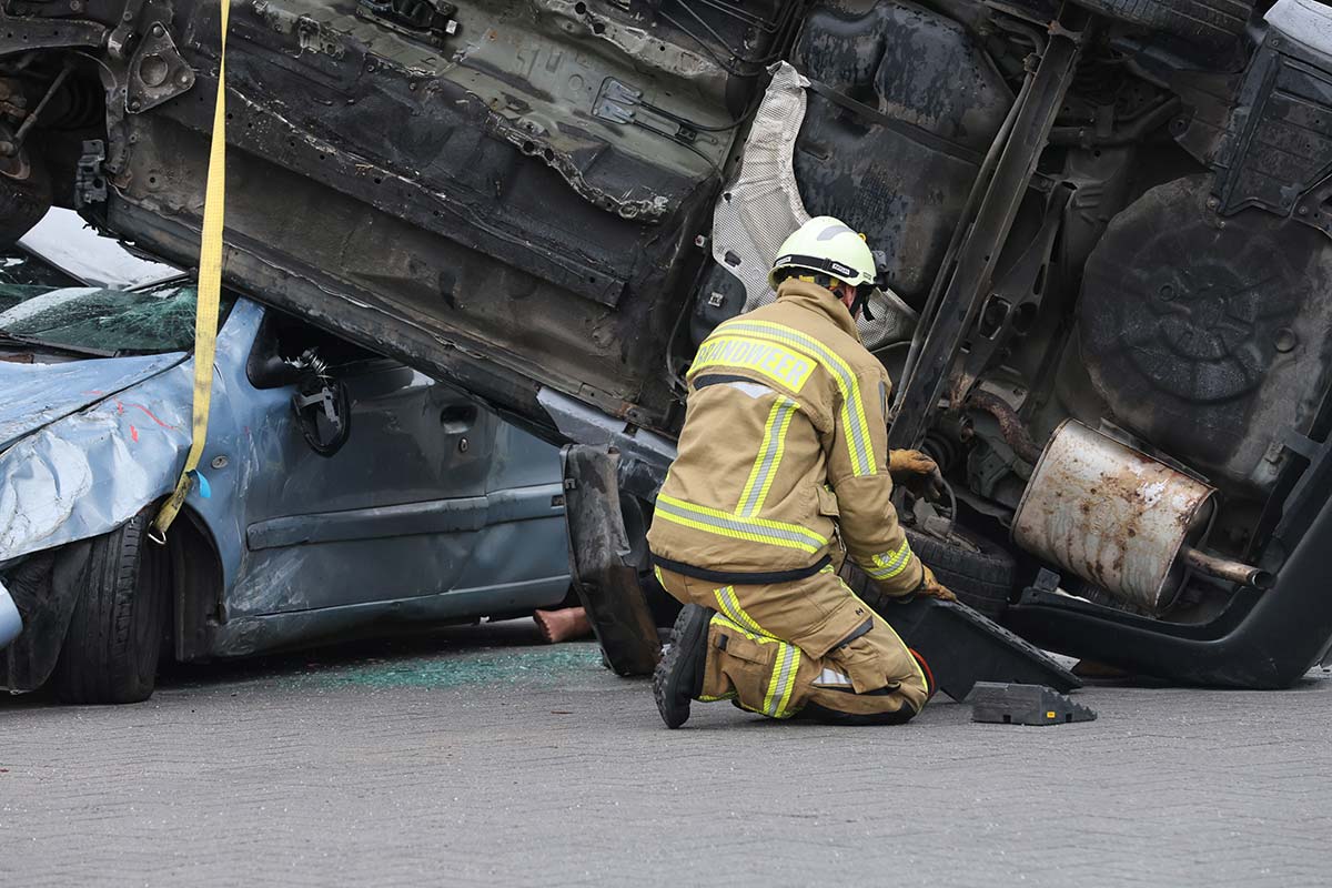 A person working on a wrecked car, illustrating the importance of contacting Greenville car accident lawyers