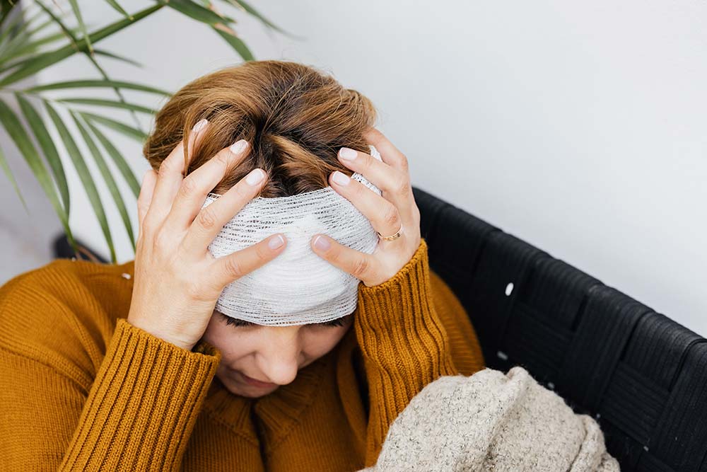 An injured woman holding her bandaged head, a type of case handled by Columbia personal injury attorneys